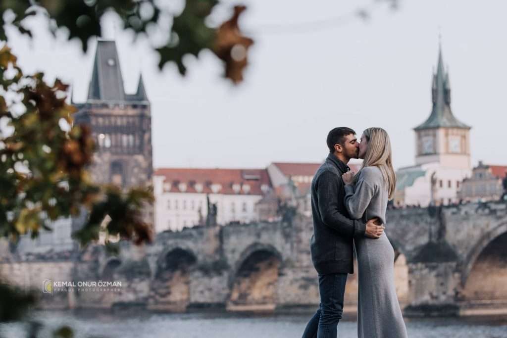 Romantic couple and at the background yo ucan see Charles Bridge and it's tower (Old Town Bridge Tower)