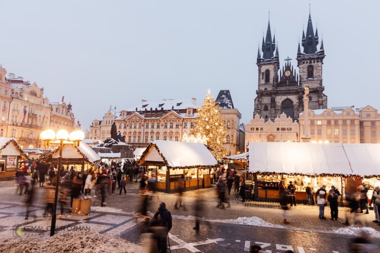 Christmas market stalls on Old Town Square under snow